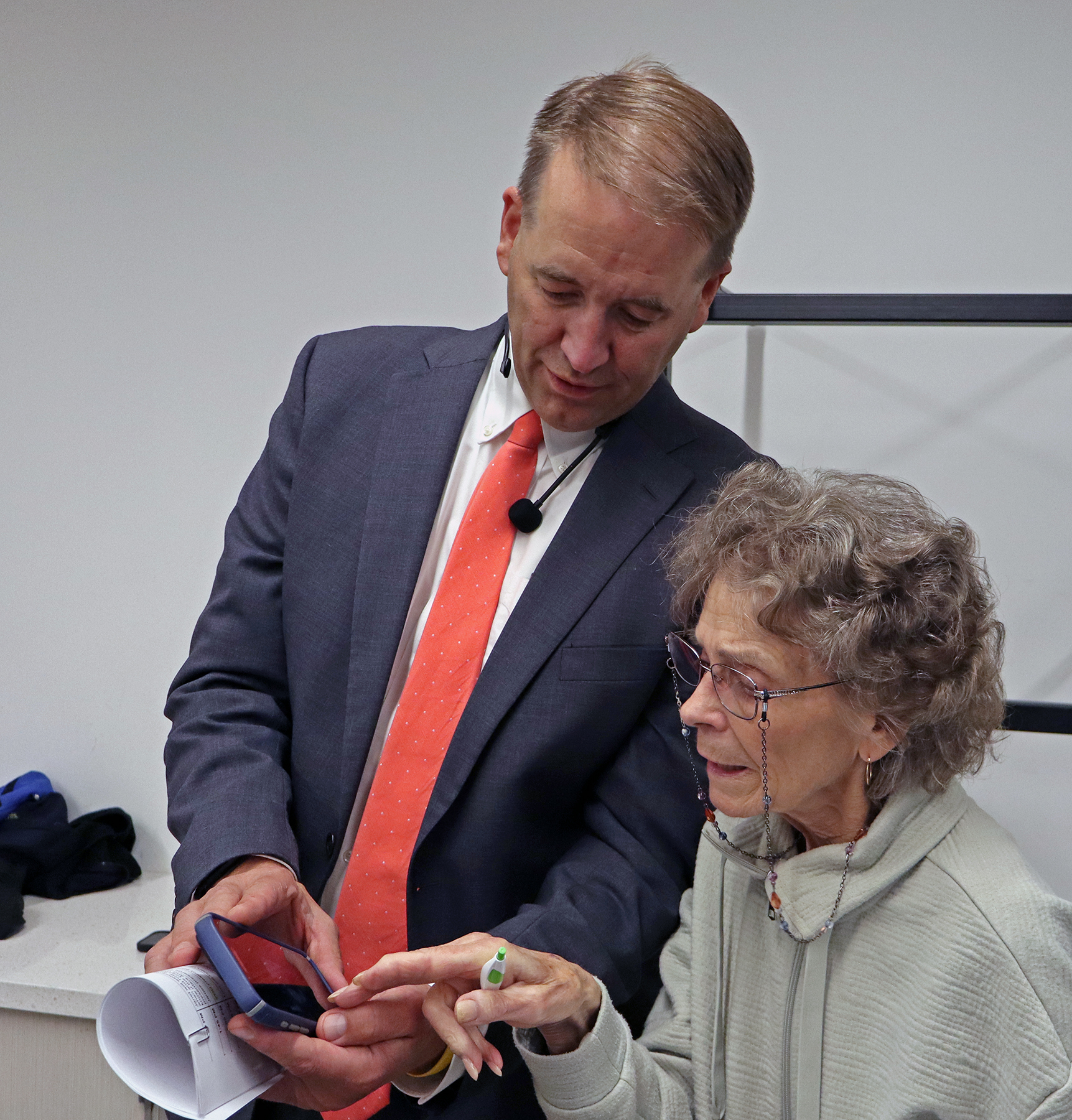 SOS Tobias Read standing with a community member, looking to be explaining something to her