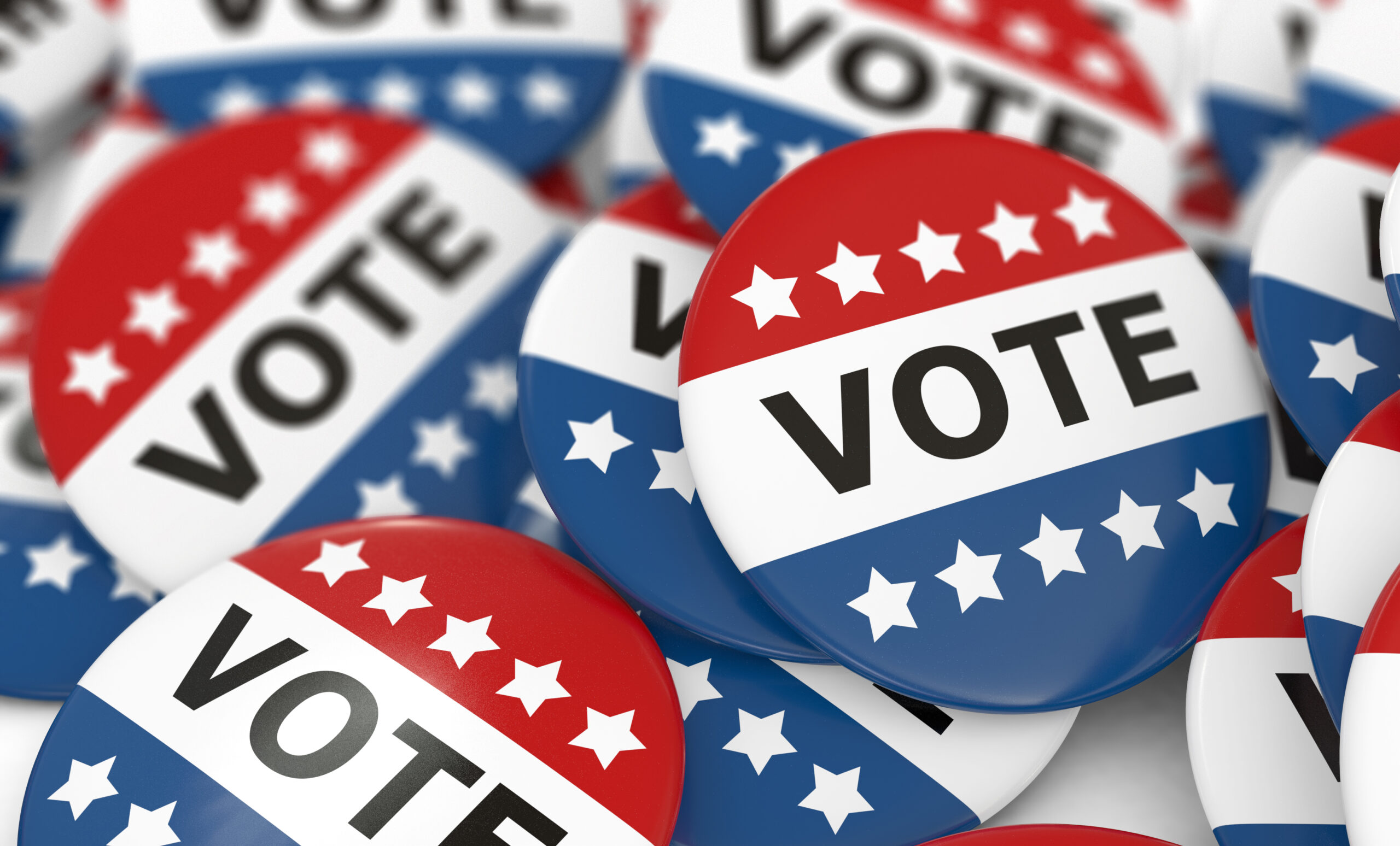 Red, white, and blue colored campaign buttons with the word "VOTE" on them, surrounded by stars.