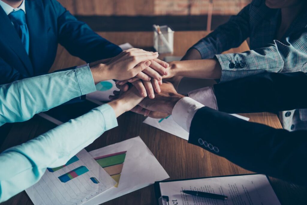 group putting hands together to agree