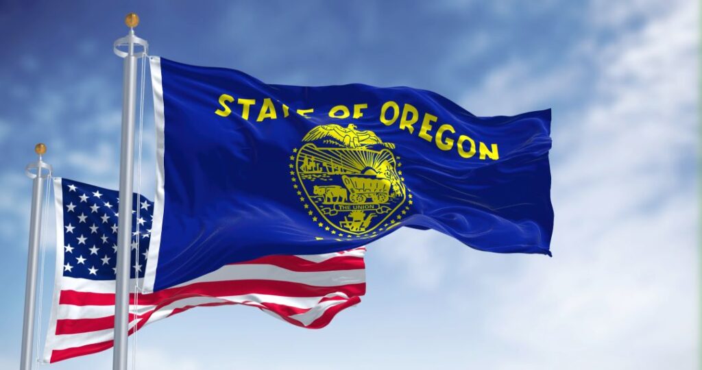 State of oregon flag waving with US flag, sunny day