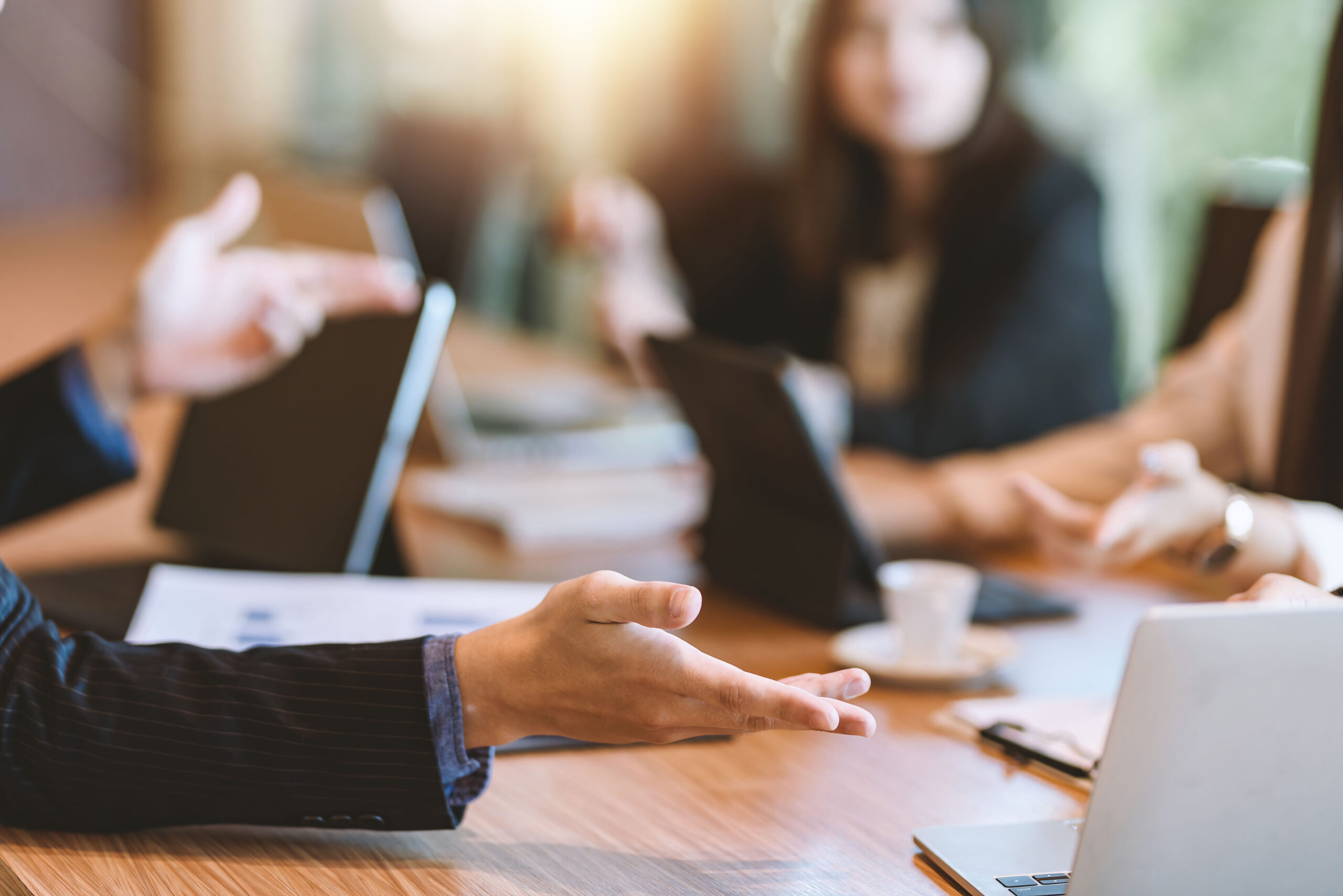 People have a discussion around a meeting table